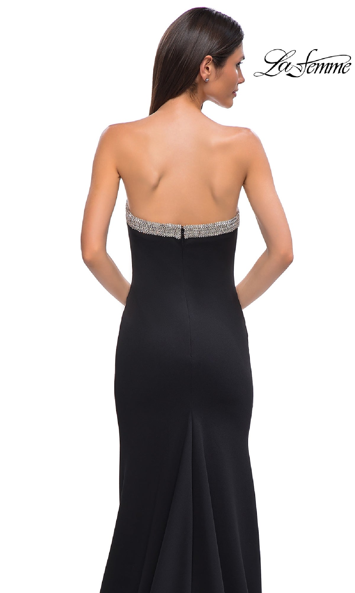 A woman with long brown hair faces away, wearing the Bead-Trimmed Long Prom Dress: La Femme 32891. The elegant black strapless gown highlights her silhouette, as the La Femme logo is shown in the top right corner.